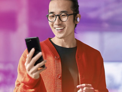 a person watching a mobile with smile